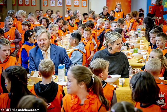 The royal couple were photographed sitting at the lunch table with students as they dined on sandwiches, fruit and water in the school cafeteria.