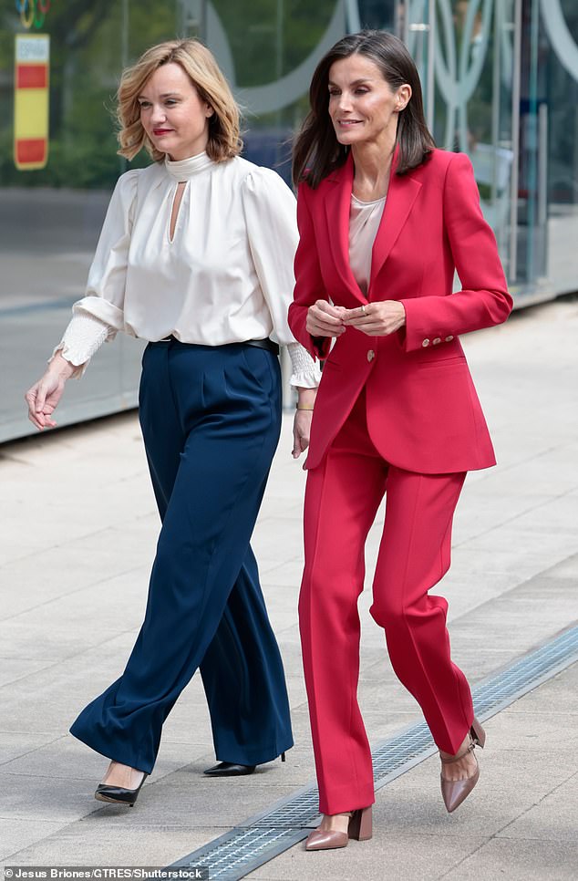 Letizia, 51, sported a scarlet single-breasted jacket with a pair of matching skinny pants.  She was wearing a simple silk top under her jacket.