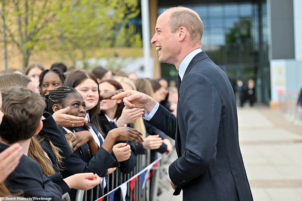 Prince William, Prince of Wales, smiled as he was greeted by school children during his visit to St. Michael's Church of England School in Birmingham yesterday.  He seemed very happy, perhaps after hearing the good news about his father.