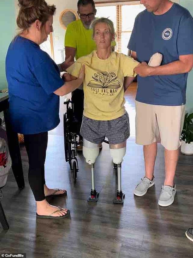 Updates posted on GoFundMe show Mullins being held by her family as she takes her first steps at home on artificial legs.