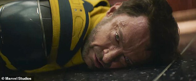 Wolverine looks mortally wounded as he lies on the ground after a fight scene.