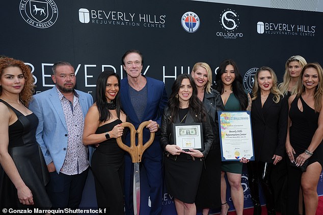 Devin posed with staff and celebrities at the center's grand opening in West Hollywood.