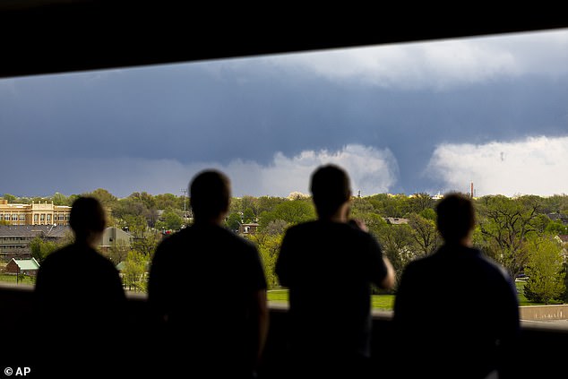 Ally Mercer, Gabe Sedlacek Kaleb Andersen and Austin Young watch a tornado from a seventh-floor parking lot on Friday in Lincoln, Nebraska.