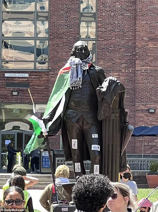 GWU protesters dressed a statue of George Washington in a Palestinian flag and a traditional keffiyeh scarf.