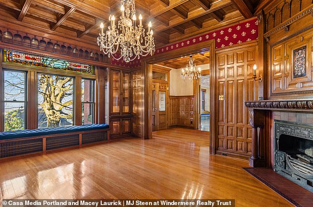 The wooden floor, walls and ceilings are seen in this photo of the ballroom of the house itself.