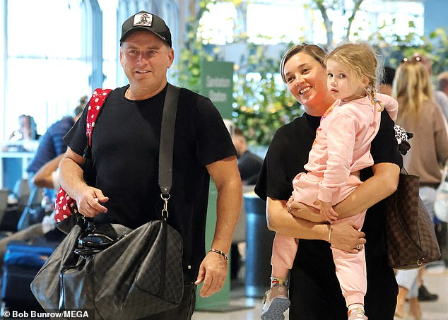 The family was all smiles as they strolled through the airport and headed to their flight.