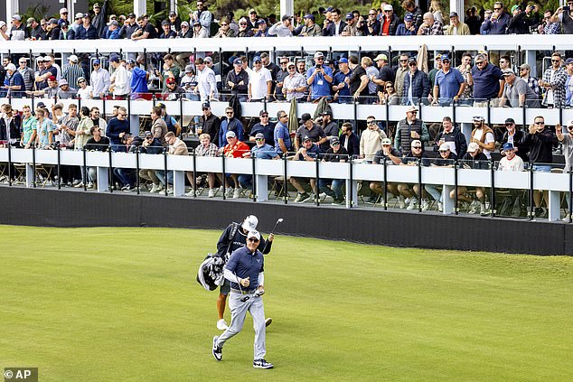 Captain Phil Mickelson of HyFlyers GC walks past the huge crowd on the 12th hole gallery in Adelaide.