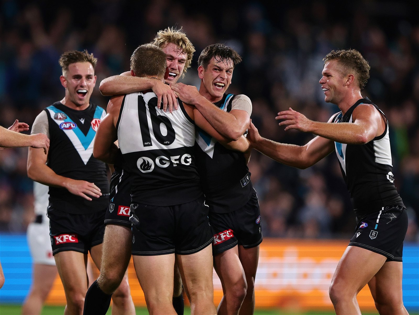 Port Adelaide players congratulate Ollie Wines after a goal against St Kilda.