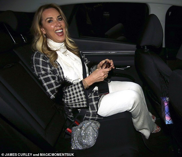 At the end of the night, Claire smiled in the back of a car wearing a jacket as the temperatures dropped.