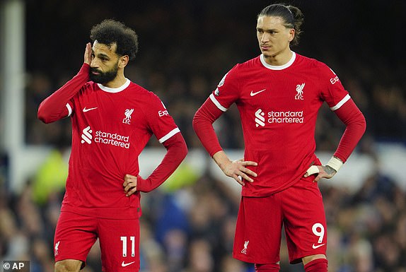 Liverpool's Mohamed Salah, left, and Liverpool's Darwin Nunez react during the English Premier League soccer match between Everton and Liverpool at the Goodison Park stadium in Liverpool, Britain, Wednesday, April 24, 2024. (AP Photo/ Jon Super)