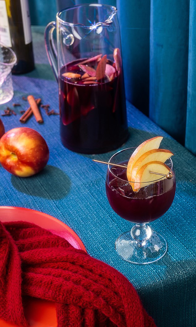 Each chapter of the book covers cocktails to drink at various stages of a love story: heartbreak, fury, healing, celebration, comfort, longing and love (Pictured: Sad Girl Sangria inspired by Swift's 10-minute breakup ballad , 'All Too Well')