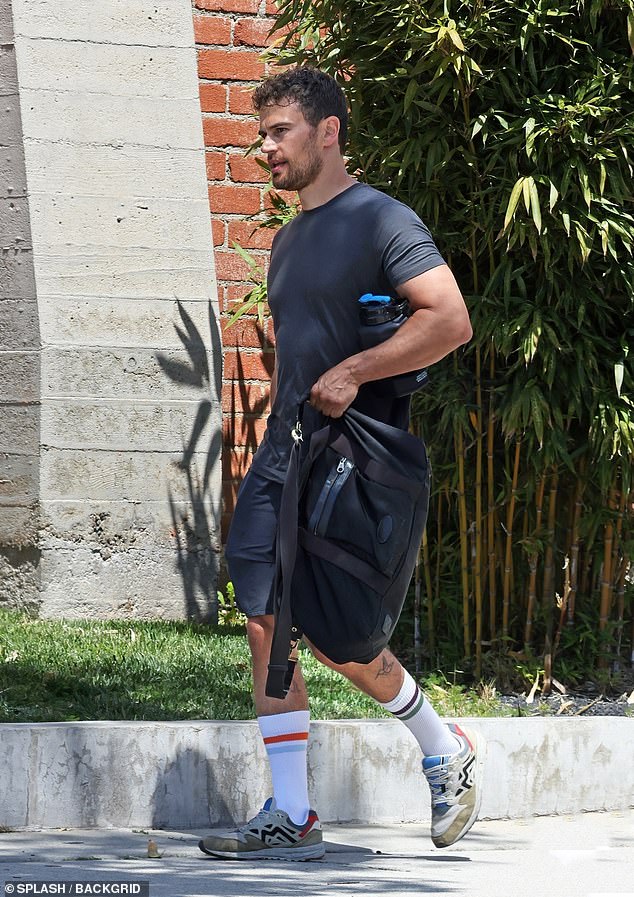 The Gentlemen star, 39, showed off his gym-honed physique as he wore a gray T-shirt and matching shorts for the outing.