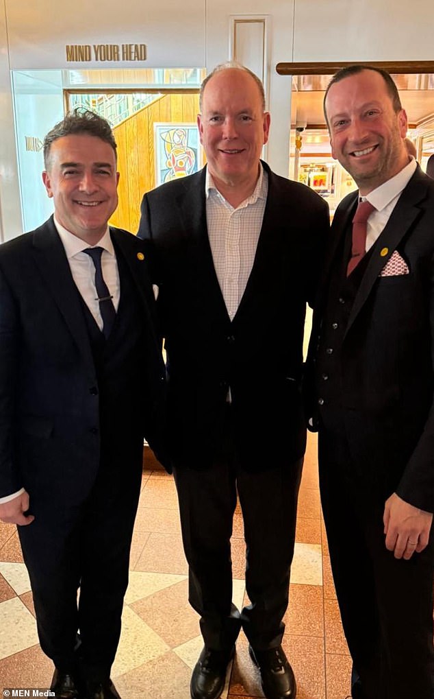 Prince Albert of Monaco (C) is pictured with two managers of the San Carlo Italian restaurant, based in Alderley Edge last Friday.