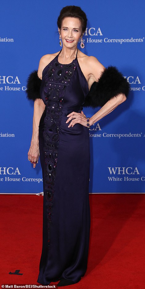 Wonder Woman actress Lynda Carter stunned in a dark navy blue dress that hugged her body and had dazzling details on the front.