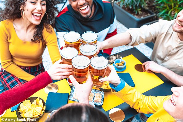 Friends enjoying a beer.  Over the past week, an avalanche of worrying research has been published on the harm caused by alcohol: even just one glass of wine a day puts us at higher risk of cancer and liver damage (file image)
