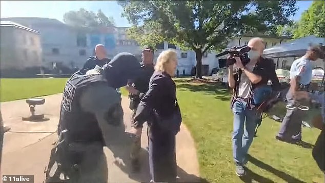 Noëlle McAfee, chair of the Atlanta school's philosophy department, was seen on video being led away in handcuffs Thursday afternoon.