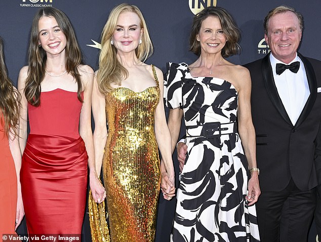 Faith and Sunday beamed with filial pride as they stood next to their mother, who wore a sparkling gold Balenciaga dress.