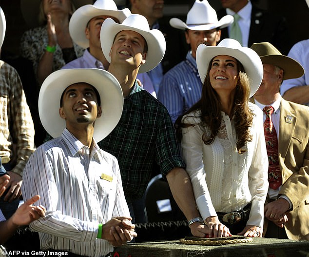 The couple smiles while attending the Calgary Stampede during a tour of Canada in 2011.