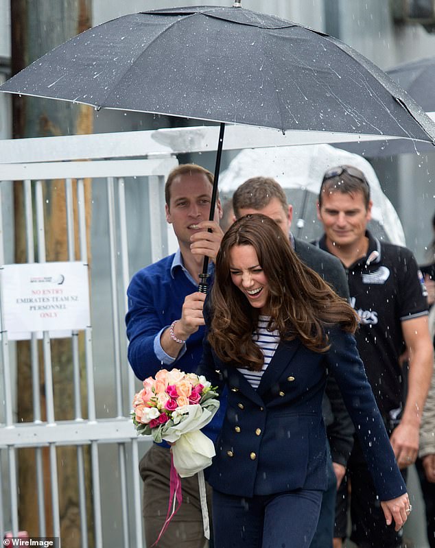 William held an umbrella over Kate on a visit to Auckland Harbor in New Zealand in 2014.