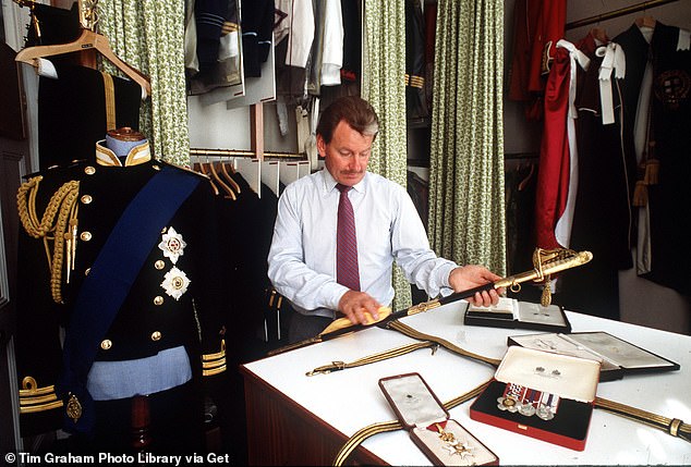 Prince Charles' valet Ken Stronach in the uniform room at Kensington Palace cleaning a ceremonial sword