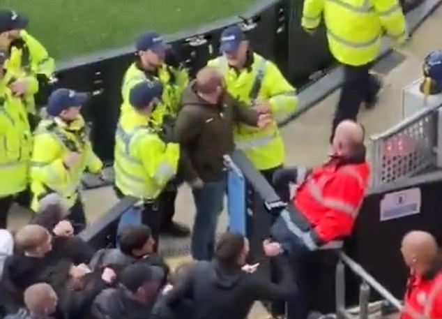 Later footage showed the man being escorted by stewards from the Manchester derby.