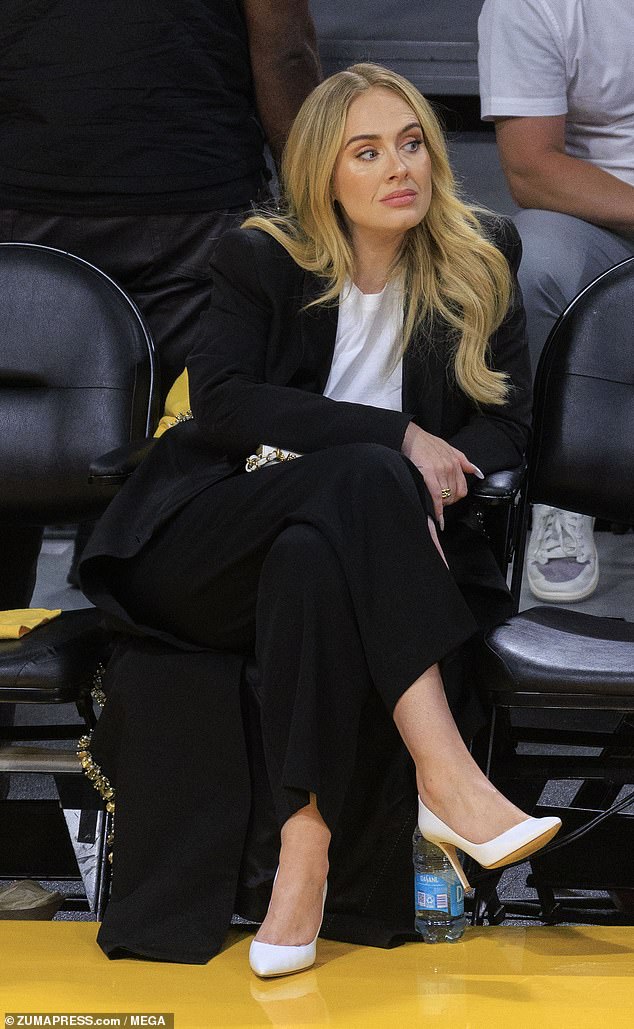 The Grammy winner sat on the court wearing a black suit with a white blouse and white heels.