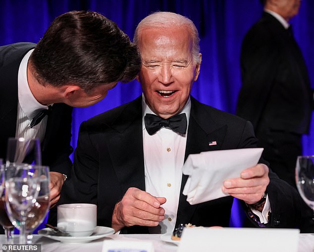 US President Joe Biden reacts when host Colin Jost speaks to him
