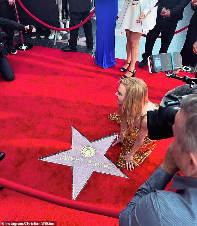 Christian captured the actress gracefully kneeling next to her star on the Walk of Fame on Hollywood Blvd in her figure-hugging sparkly gold dress.