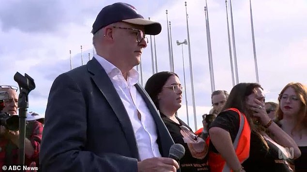 Anthony Albanese pictured during his speech at the Women's March Against Gender Violence, while organizer Sarah Williams looks visibly upset (right)