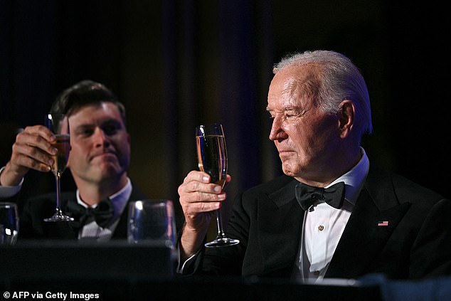 Biden toasts with comedian Colin Jost during the event