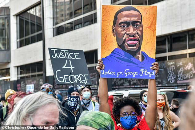 Protesters held portraits of George Floyd and signs calling for 