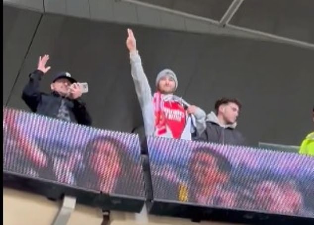 An Arsenal fan was allowed onto the home pitch and one fan revealed his Gunners shirt after the final whistle to celebrate the victory.