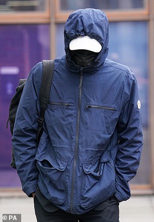 Tottenham fan Joseph Watts, 35, hides his face as he leaves Uxbridge Magistrates' Court, west London, after pleading guilty to assaulting Arsenal's Aaron Ramsdale at the Tottenham Hotspur stadium.