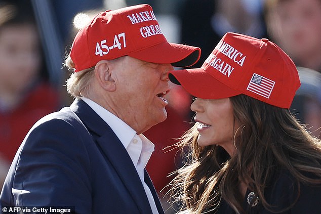 Republican presidential candidate Donald Trump speaks with North Dakota Governor Kristi Noem during a Buckeye Values ​​PAC rally in Vandalia, Ohio, on March 16, 2024.