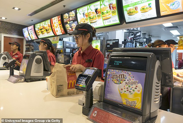 Workers employed by restaurants and fast food chains (pictured) have already been affected by artificial intelligence technologies as the food service sector prepares for more changes.