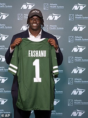 New York Jets rookie offensive tackle Olu Fashanu poses with his jersey