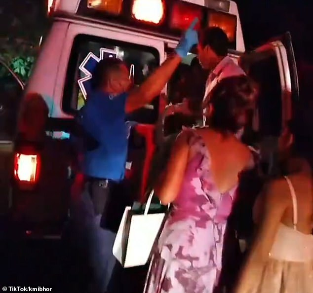 A paramedic shouts instructions to guests at a wedding in Cuernavaca, Mexico, after at least 100 people fell ill from eating dessert.