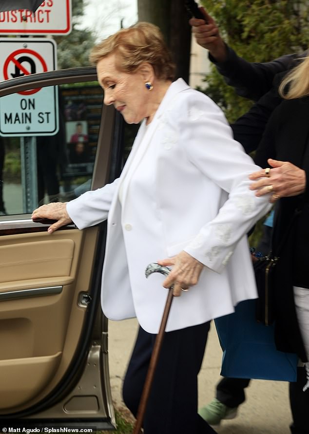 She looked as stylish as ever in a white jacket and black pants and accessorized with gold and blue earrings.