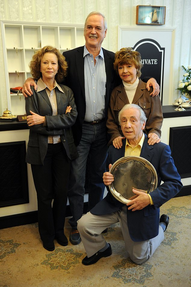 The former co-stars recreated the shot after meeting at a Fawlty Towers event in 2009.