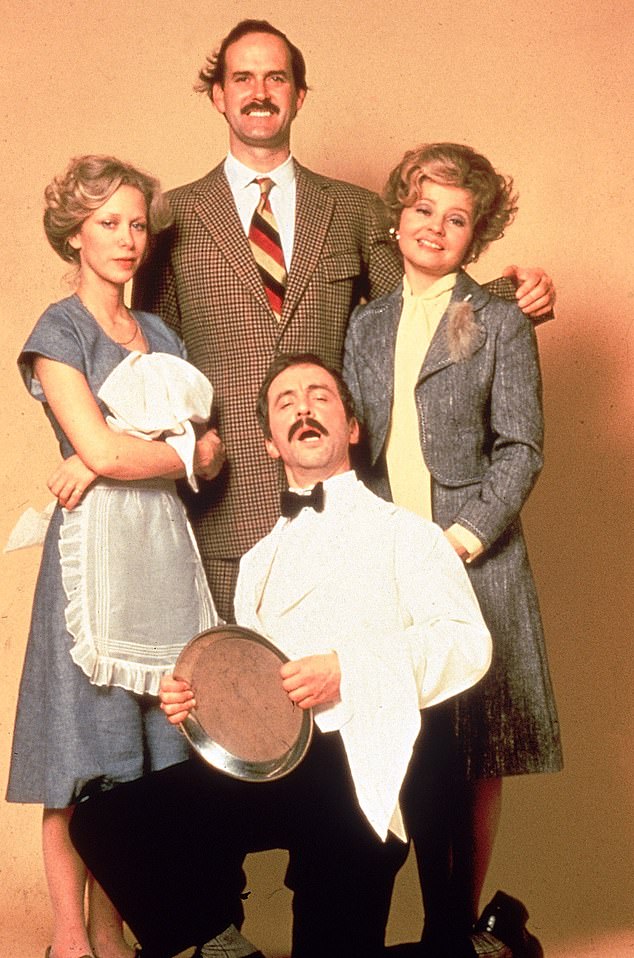 From left to right: Connie Booth as Polly, John Cleese as Basil Fawlty, Prunella Scales as Sybil Fawlty and Andrew Sachs (kneeling) as the hapless Spanish waiter Manuel in a promotional photo.