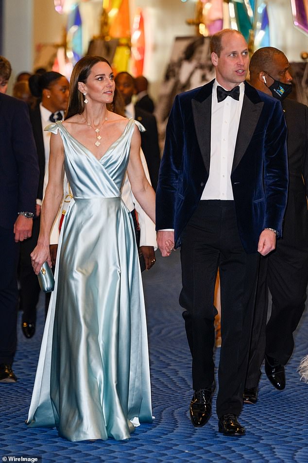 The Prince and Princess of Wales are photographed walking hand in hand during a reception in the Bahamas in 2022.