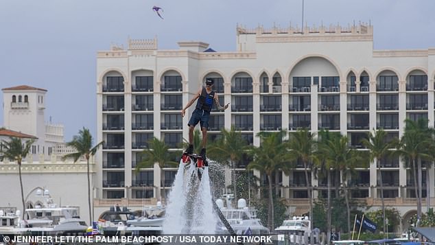 A man was also seen flying in the sky attached to a water jetpack with a phone in his hand.