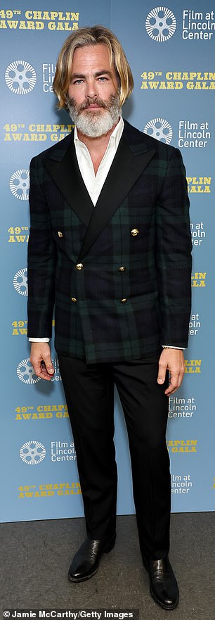 The Emmy nominee, 43, wore a blue and green plaid double-breasted jacket over a white button-down shirt with no tie, black pants and shiny boots.