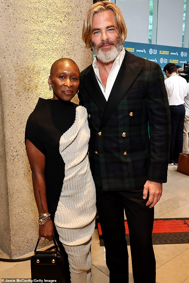 Chris posed for a photo with fellow speaker Cynthia Erivo, who wore a black and beige knit sweater dress.