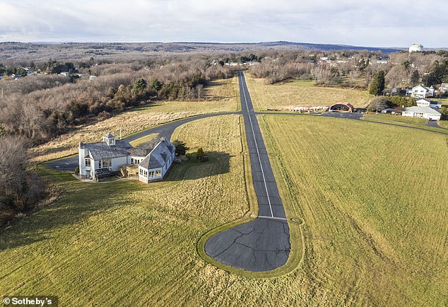 Located atop a hill with stunning views, this modern property spans 49 acres and offers over 5,000 square feet of living space and a private landing strip.
