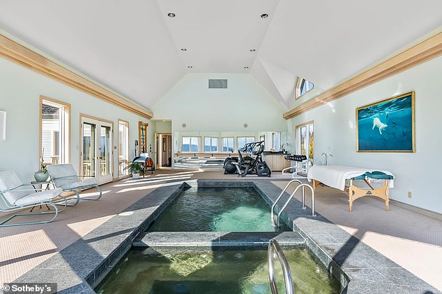 A hot tub is located at the other end of the pool house.