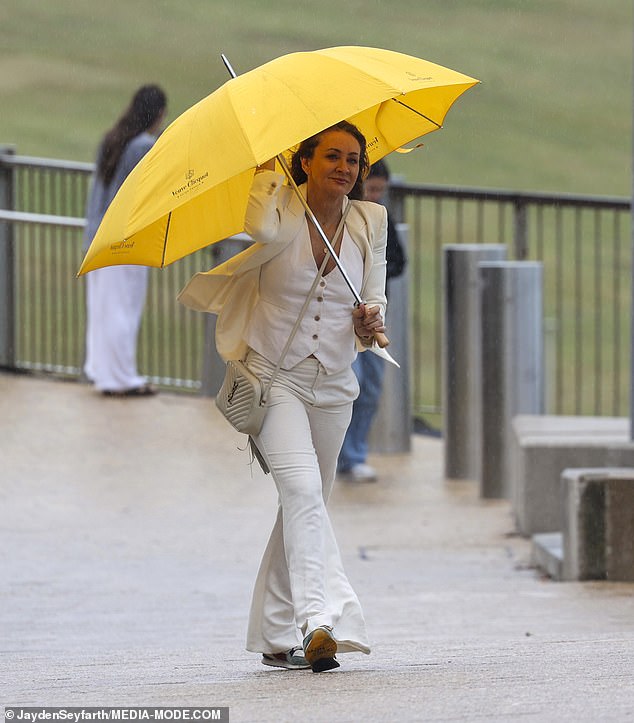 Michelle Bridges was next to arrive, sliding her fit figure into a cream three-piece suit that included a vest.