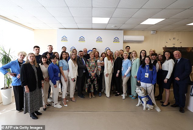 Sophie poses for a photograph with people at the UNFPPA office, and the Duchess 