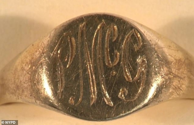 A gold signet ring engraved with 'PMcG' (pictured) was found on one finger, and on his wrist was a 1960s Bulova watch. The body was also buried with a dime minted in 1969 and a classic green toy soldier.