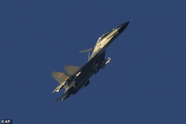 A Chinese J-11 military fighter jet flies over the Taiwan Strait near Pingtan, the closest mainland land to Taiwan island, in southeast China's Fujian Province, Friday, Aug. 5, 2022.